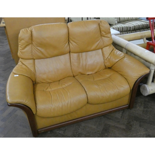 99 - A Ekornes Stressless two seater settee in pale brown leather