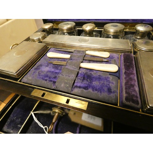 580 - A Victorian Coromandel fitted dressing table box containing ten silver topped bottles and boxes with... 