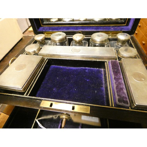 580 - A Victorian Coromandel fitted dressing table box containing ten silver topped bottles and boxes with... 