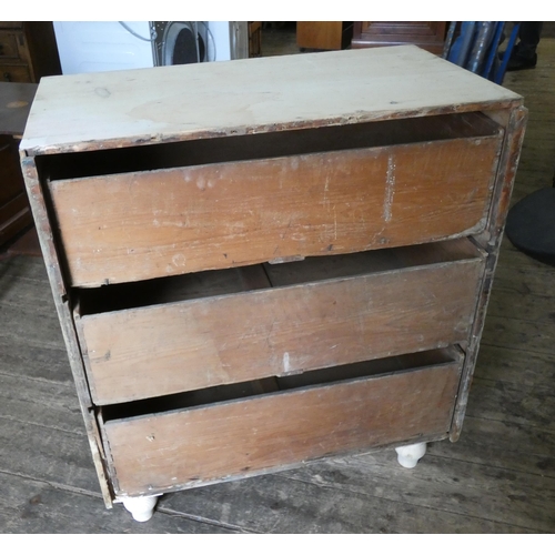 15 - A stripped pine chest of three long drawers with bun handles 2'9