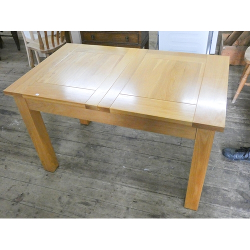 72 - A heavy modern light oak extending dining table with fold away centre leaf 50