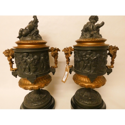 203 - A pair of French bronze and gilt metal mounted urns. The lids with cherub finials. Each standing 42c... 