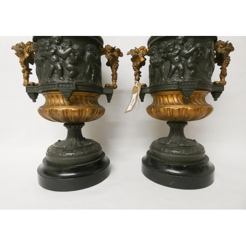 203 - A pair of French bronze and gilt metal mounted urns. The lids with cherub finials. Each standing 42c... 