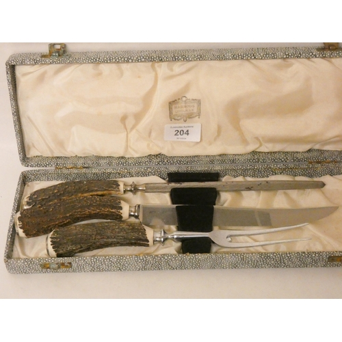 204 - A country house antler mounted carving set retailed by Harrods in a fitted box