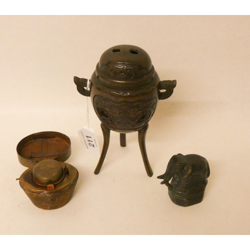 211 - A Japanese bronze incense burner on tripod stand, an elephant shaped opium weight and a hat box shap... 