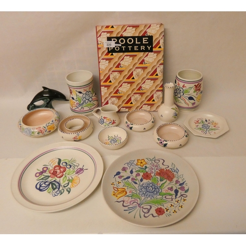 220 - A large collection of traditional floral decorated Poole Pottery and a copy of the Poole Pottery ref... 