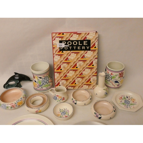 220 - A large collection of traditional floral decorated Poole Pottery and a copy of the Poole Pottery ref... 