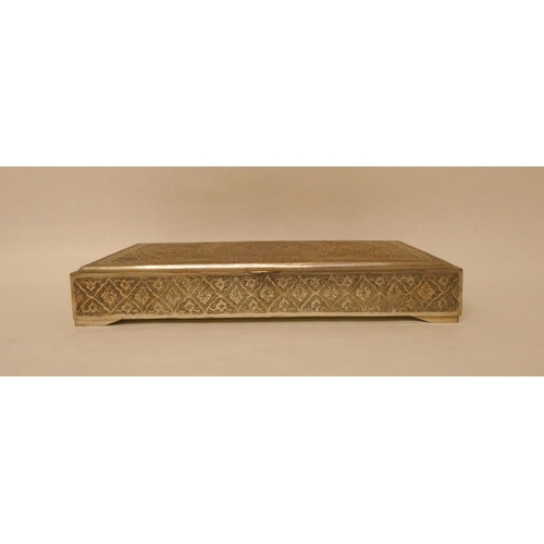 502 - A Persian white metal table top rectangular cigarette box with hinged lid with engraved decoration. ... 