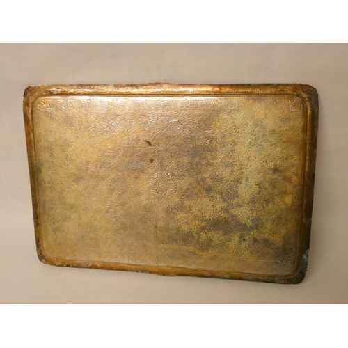 506 - A large Persian rectangular tea tray with all over engraved decoration. Unmarked white metal. 46cm a... 