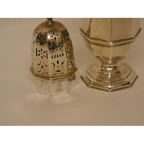 511 - A Mappin & Webb octagonal bodied, hallmarked silver sugar shaker. 20cm tall. Hallmarked London 1918.... 