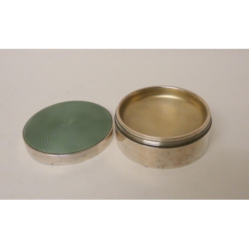 515 - A good quality silver dressing table powder box with jade green engine turned enamel lid, in a liner... 