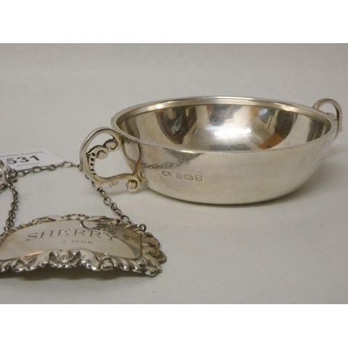 531 - A collection of small silver items - two decanter labels, spur shaped sugar nips and a wine taster. ... 