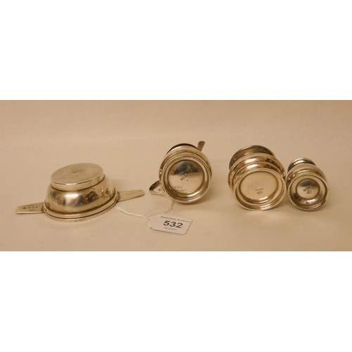 532 - An Art Deco silver tea strainer and stand by Elkington and a silver three piece cruet set