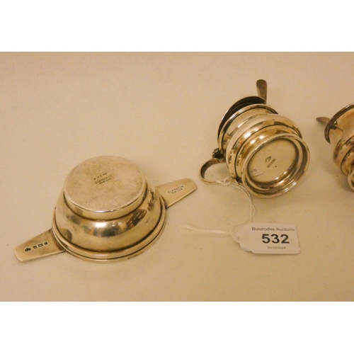 532 - An Art Deco silver tea strainer and stand by Elkington and a silver three piece cruet set