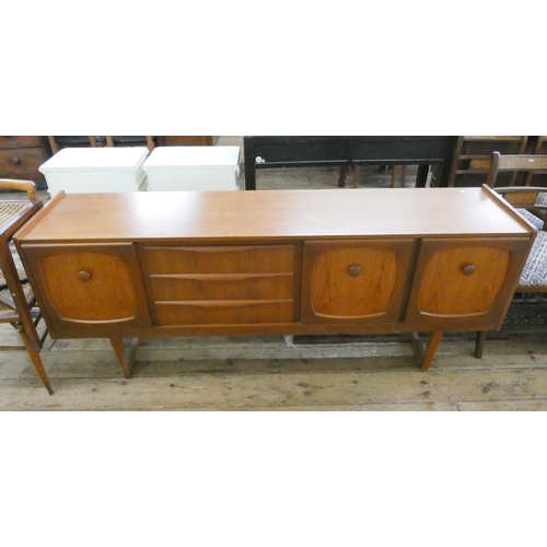 104 - An 1980's long low teak sideboard fitted cupboards and three drawers. 6' long