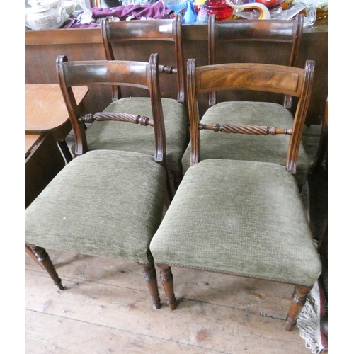 86 - A set of four regency mahogany rope back dining chairs standing on turned legs with dark green uphol... 