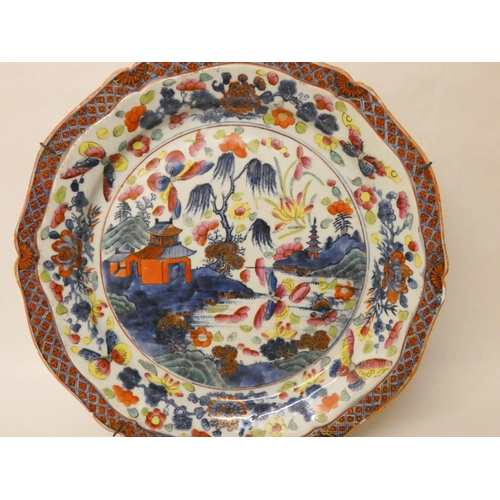 236 - A large Japanese bordered charger plate decorated with butterflies and flowers. 38cm diameter