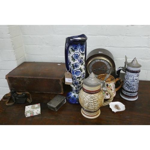 141 - A twin handled Art Nouveau vase, mantel clock, tankards, leather case, binoculars etc