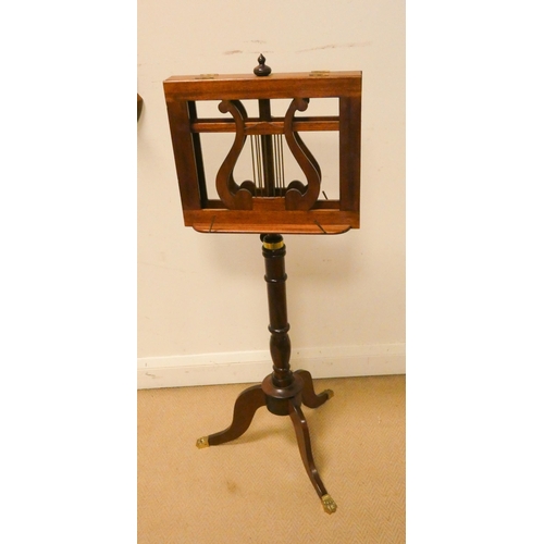 169 - A Georgian style double sided mahogany music stand with lyre decoration standing a pillar and tripod... 