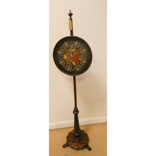 170 - A Victorian rosewood pole screen with floral tapestry upholstery standing on a pillar and platform s... 