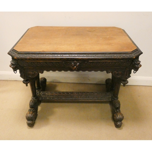 343 - A Victorian carved oak centre table fitted one drawer, carved with lion masks and on a dolphin style... 