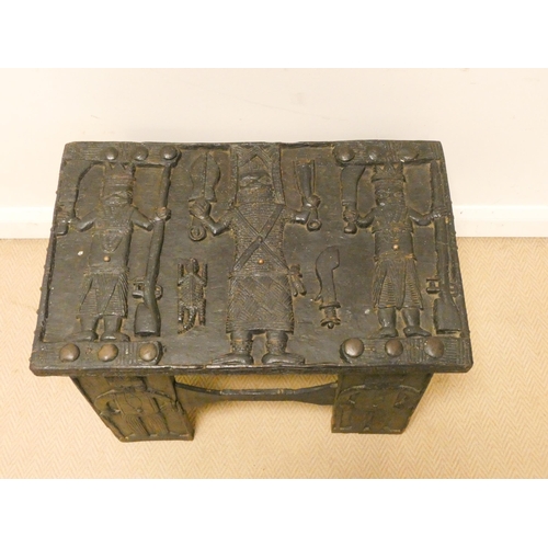 353 - An unusual tribal ebonised carved occasional table, carved with figures