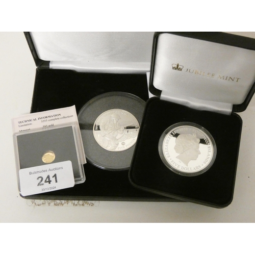 241 - Two Crown size silver coins in their presentation boxes together with a 1/2 gram of 15 carat gold co... 