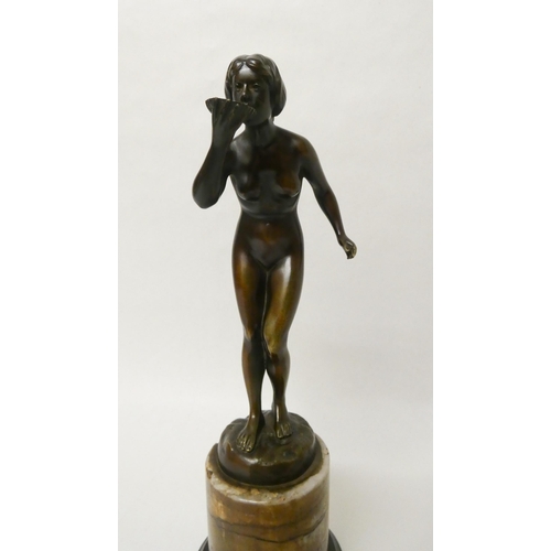 255 - Hans Rieder, (German, early 20th century). An Art Deco brown patinated bronze study of a nude female... 