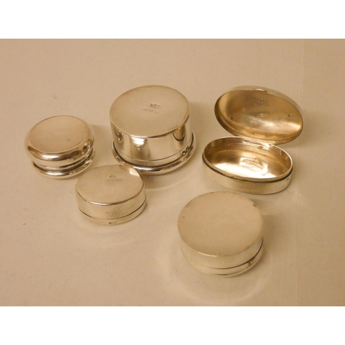 535 - A collection of five hallmarked silver pill boxes of plain form.