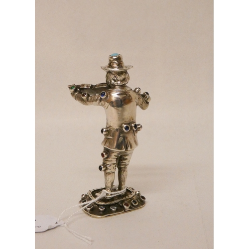 541 - A continental silver and gem inlaid model of a violinist. Makers mark only WG. 10.5cm tall.