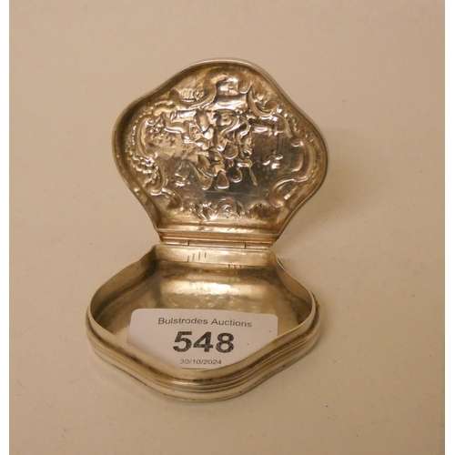 548 - A Dutch shaped silver snuff box with hinged lid decorated with cherubs. 1.7 troy ozs. 6cm across