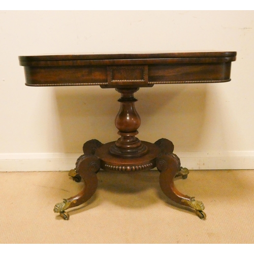 375 - A William IV mahogany fold over top card table on a pillar and platform base. Legs terminating in br... 