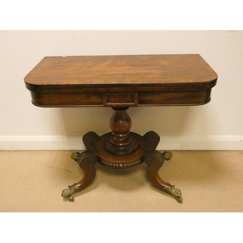 375 - A William IV mahogany fold over top card table on a pillar and platform base. Legs terminating in br... 