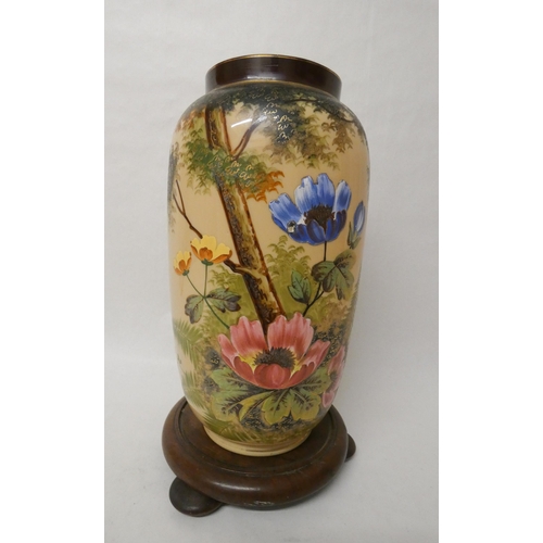 378 - A late 19th century enamelled glass vase painted with poppies on a wooden base. Vase height 34cm tal... 