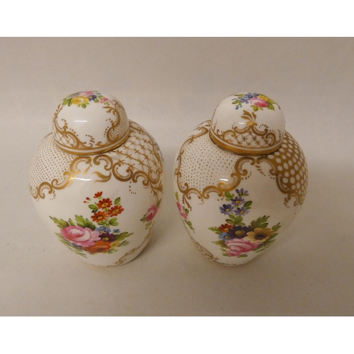 247 - A pair of late 19th century/early 20th century gilt and floral decorated ginger jars in the style of... 