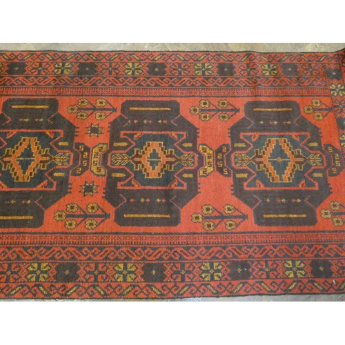 397 - A modern Persian design red ground carpet decorated with three medallions  measuring 79