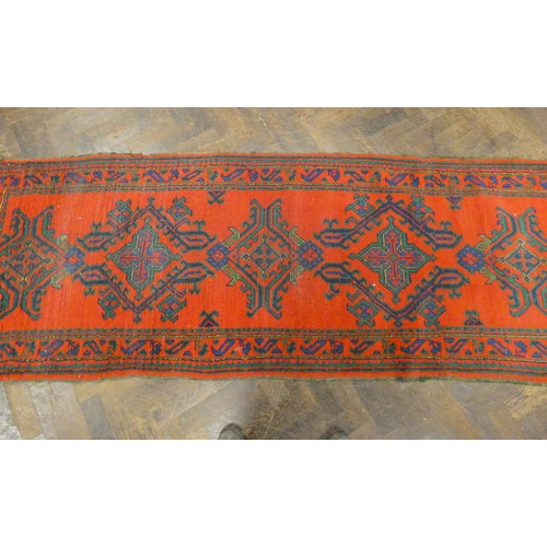 398 - A red Turkish carpet runner 98