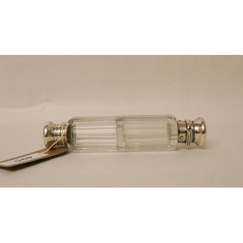 495 - A Victorian double ended clear glass scent bottle, the hinged lid to one end marked West St James's ... 