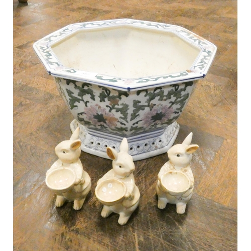 367 - A octagonal Chinese style fishbowl planter and three pottery figures of rabbits