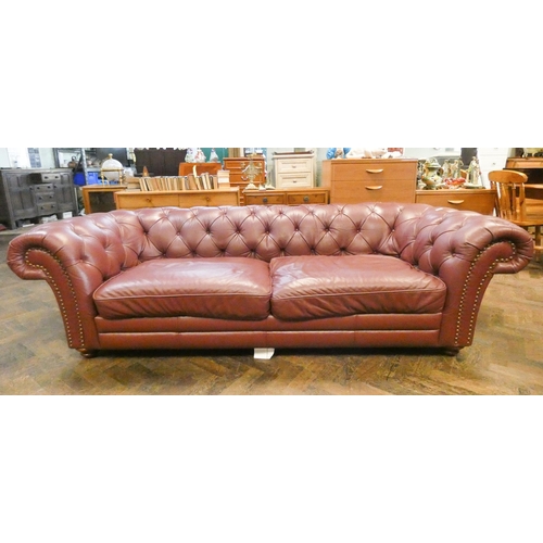 389 - A large two seater Chesterfield buttoned sofa upholstered in Oxblood leather. 2.4m x 104cm deep