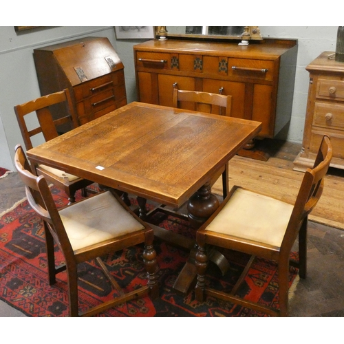 391 - A 1930's golden oak dining suite comprising square drawer leaf table, four matching chairs, two draw... 