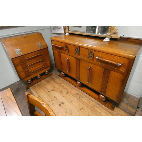 391 - A 1930's golden oak dining suite comprising square drawer leaf table, four matching chairs, two draw... 