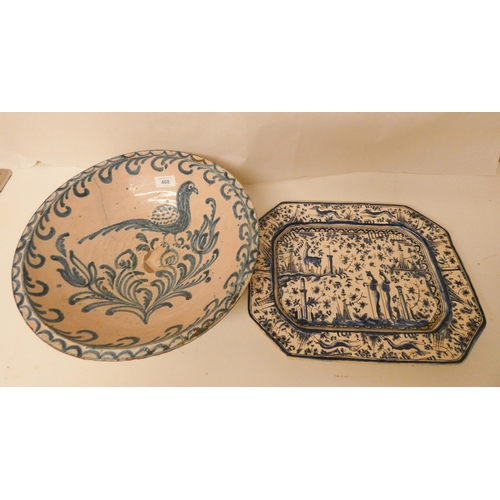 408 - A large Italian pottery bowl with old riveted decoration and a blue and white Italian meat plate