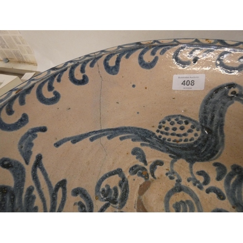 408 - A large Italian pottery bowl with old riveted decoration and a blue and white Italian meat plate