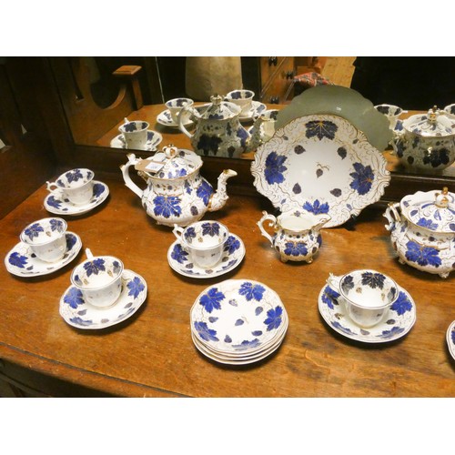 226 - A residue of a Victorian tea service decorated in blue, white and gilt grape leaves