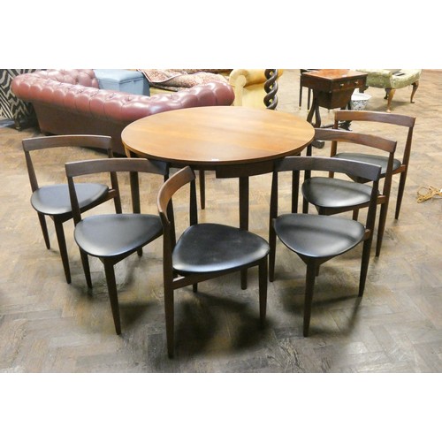 433 - A Danish Frem Rojle Roundette circular teak dining table with fold away centre leaf and six matching... 