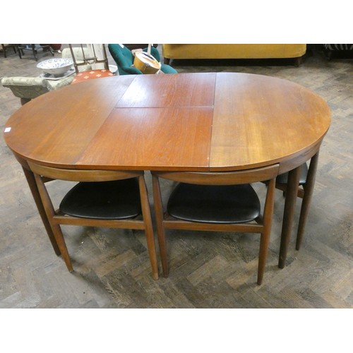 433 - A Danish Frem Rojle Roundette circular teak dining table with fold away centre leaf and six matching... 