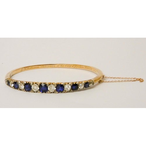 707 - An early 20th century old cut sapphire and diamond hinged bangle, set with seven circular sapphires ... 