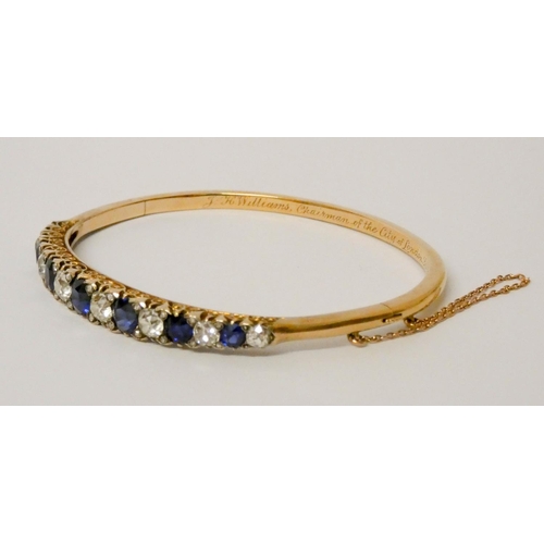 707 - An early 20th century old cut sapphire and diamond hinged bangle, set with seven circular sapphires ... 