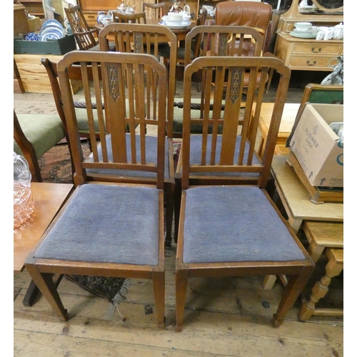 67 - A set of four Edwardian oak dining chairs with blue upholstered seats